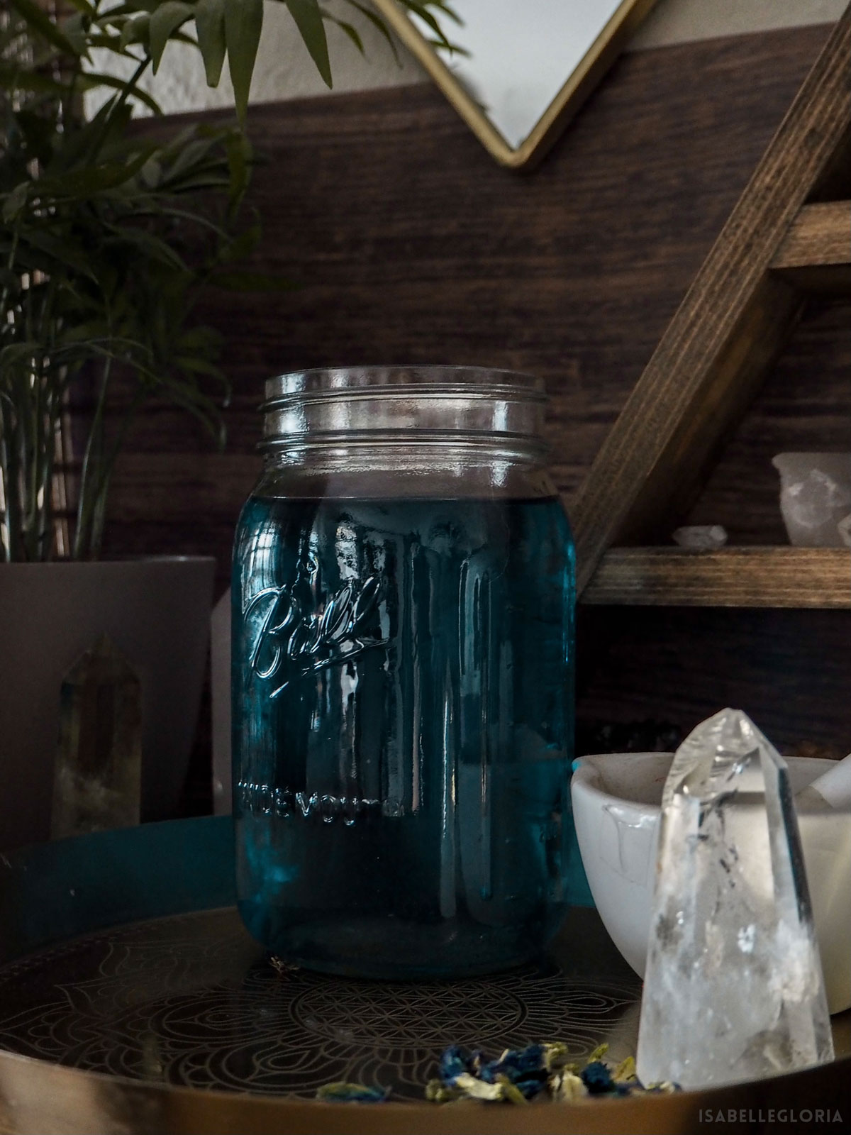 blue tea mason jar on desk with crystal points